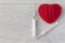 An old mercury thermometer with syringe and red heart on wood background. Medical health care