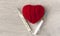 An old mercury thermometer with syringe and red heart on wood background. Medical health care