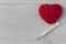 An old mercury thermometer with syringe and red heart on wood background. Medical health care