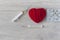 An old mercury thermometer with syringe and red heart on wood background. Medical health care