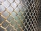 Old mesh netting. Metal mesh covered with the remains of old white paint. Vintage background