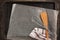 Old metal baking pan with paper and kitchen utensils