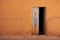 Old metal blue door in earth wall. House of clay and straw. Morocco, tinghir. Traditional house of morcco.Small village.