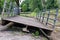 Old metal bridge removed from its place and temporarily placed on the bank of a stream