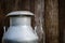 Old metal can on milk on wooden background