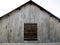 Old metal deposit with a wooden window.