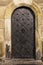 Old metal door are established in a sandstone wall, beautifully