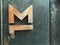 Old metal door with rivets steel. Door handle in the form of letter M. Vintage stile