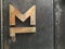 Old metal door with rivets steel. Door handle in the form of letter M. Vintage stile