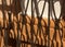 Old metal gate shadow on orange plaster wall.