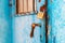 Old metal industrial door locked with brass padlock