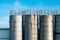 Old metal industrial silo towers for bulk and liquid materials against the sky