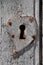 Old metal keyhole with heart-shaped patch