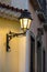 Old metal lanterns and colorful facade of a colonial house in the historic Pelourinho district