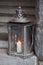 Old metal outdoor lamp with burning candle