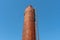 An old metal rusty water tower. Old production technology, processing, drying in the agro-industrial complex. Red silo on the sky