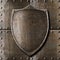 Old metal shield over armour background