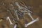 Old metal tools and screw-nuts on a dirty burlap close-up. rough surface texture