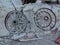 Old metal Wagon wheels lined up along mining equipment in the desert in Arizona in a deserted ghost mining town.