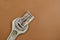 Old metal wrench and bill on a brown background