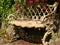 Old metallic bench with intricate designs in a park