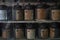 Old metallic pots of Thai traditional medicines in a pharmacy`s window in Bangkok`s Chinatown, Thailand