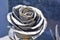 Old metallic rose flower on cemetery as sign of memory