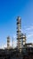 Old methanol distillation refinery column towers and reactors under blue evening sunset sky background at chemical plant