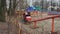 The old mini rollercoaster in the amusement park ride in a circle. People in booths have fun and rejoice.