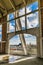 Old mining tower in remodeling with large windows looking at an intense blue sky