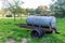 Old mobile water tank or waterer for livestock on an agricultural plot