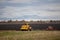 old model tractor working in the field.