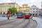 Old and modern trams on main square of Prague`s Mala Strana next to St. Nicholas Church