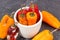 Old moldy peppers in bowl on dark background, unhealthy and disgusting vegetable