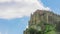 Old monastery on top of mountain. Time-lapse of clouds moving in sky over church