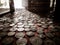 Old money coins collection behind window with sunlight in the background