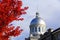 Old Montreal, Canada - October 25, 2019 - The view of the exterior dome of Bonsecours Market surrounded by striking red color of