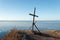 The old monument is a wooden cross and an old rusty anchor on a cliff at the extreme end of Tobizin cape on the Russian island