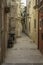 An old moped parked in a deserted street in the old downtown historic district of Ortigia, Sicily