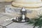 Old Moroccan lantern with decorative silver cup of Turkish tea, coffee. Date palm leaf in sunlight. Old yellow facade