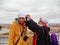 An old Moroccan is making a national turban for the European tourist.