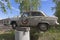 Old Moskvich-402 car on an improvised pedestal at a special parking on Tractor Street in Velsk, Arkhangelsk Region