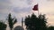 Old mosque which named Bey Cami and waving Turkish flag in Aydin Turkey