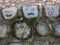 Old mossy stone wall with hand drawn faces