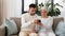 Old mother and adult son with smartphone at home