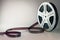Old motion picture film reel on brown background