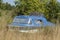 Old motorboat lying on a meadow, Varel harbor, Varel, Lower Saxony