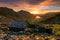 Old mountain shelter Warnscale Bothy with beautiful sunset over Buttermere in the Lake District, UK.