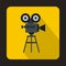 Old movie camera with reel icon, flat style