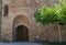 Old Mudejar style arch door in the medieval walls of the town of Buitrago de Lozoya, Spain